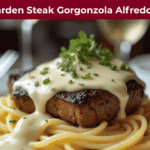 "Olive Garden Steak Gorgonzola Alfredo with creamy sauce over fettuccine pasta on elegant plate"