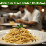 Olive Garden chefs preparing their signature Fettuccine Alfredo in the kitchen.